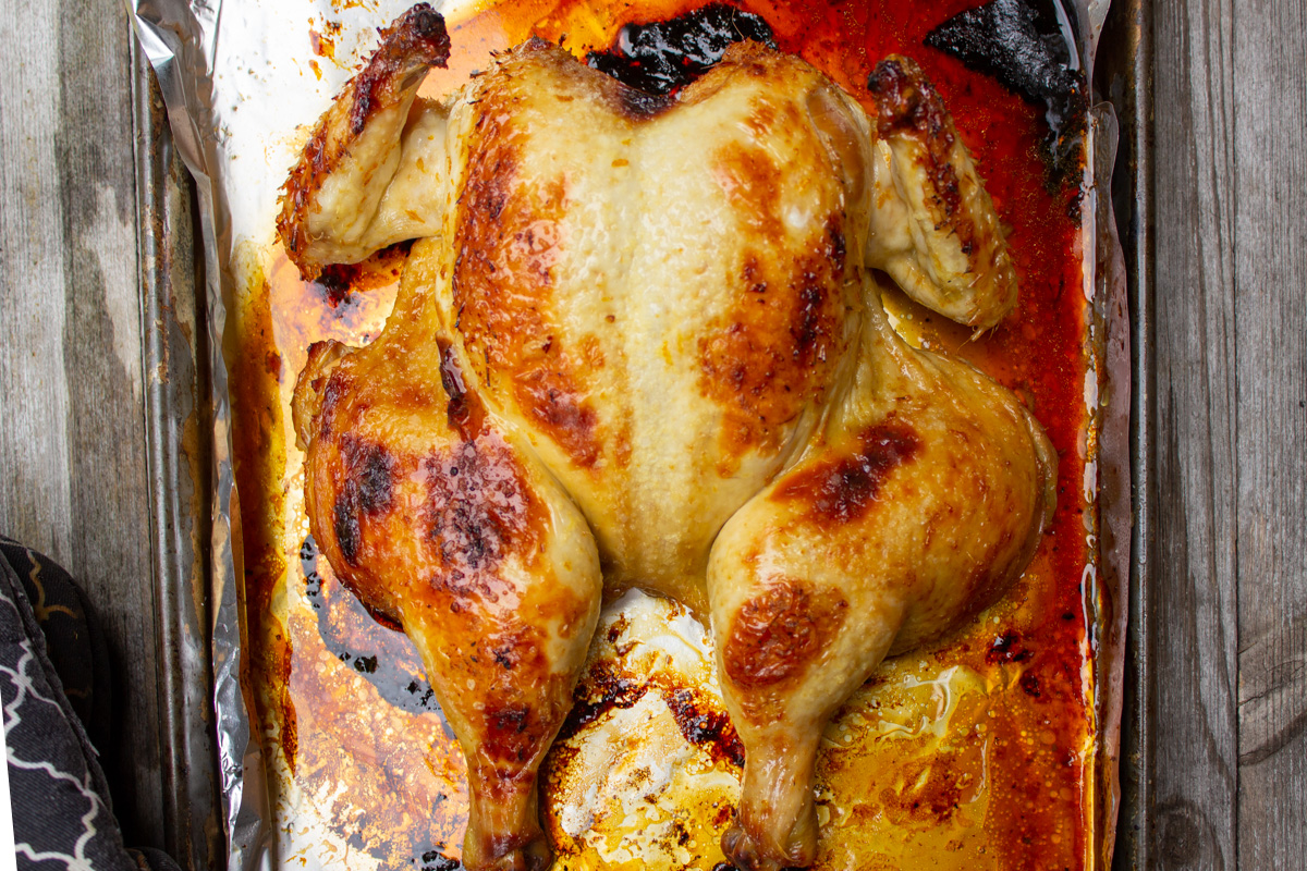 roasted butterflied chicken in pan before final glaze