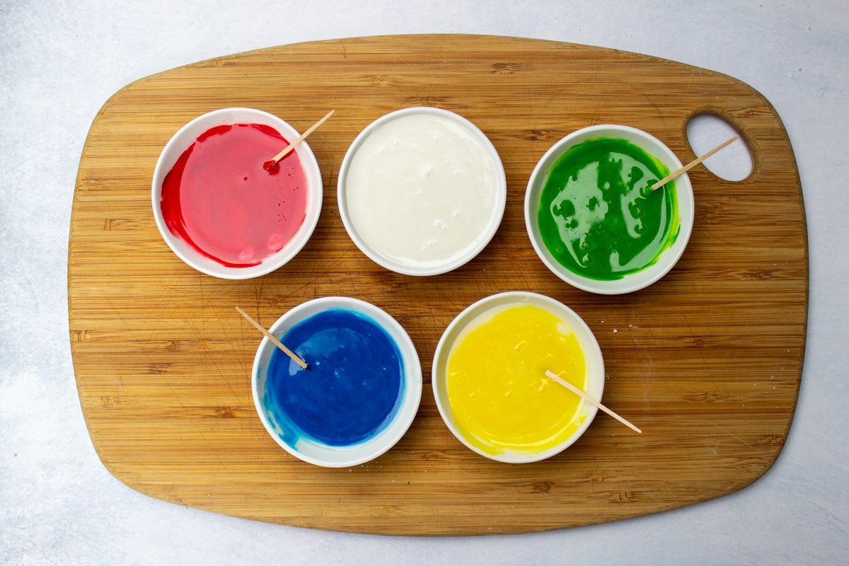 bowls of colored icing for cookies