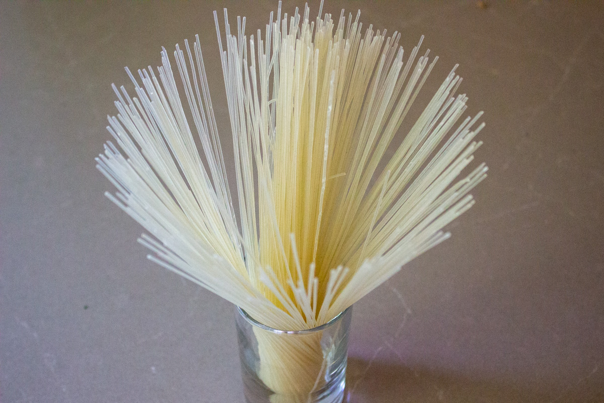 vermicelli noodles standing up in a glass