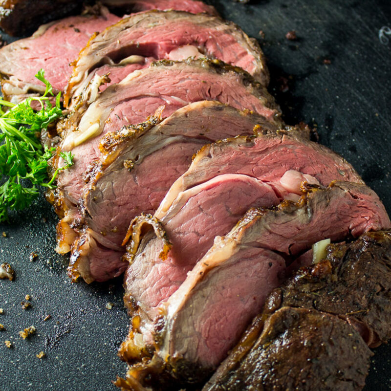 sliced prime rib roast on cutting board