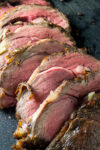 sliced prime rib roast on cutting board