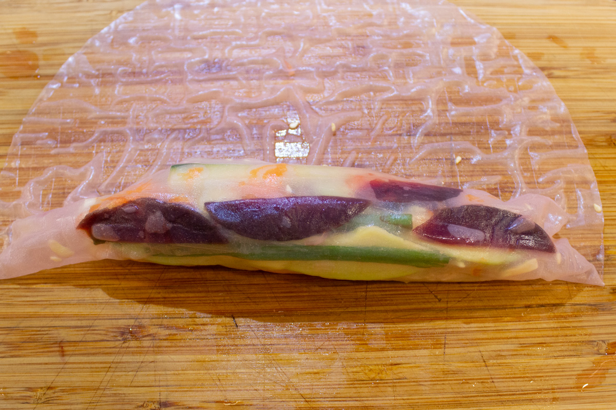 partially rolled wrapper with veggie fillings