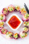 cut rice paper rolls forming a circle around dipping sauce bowl