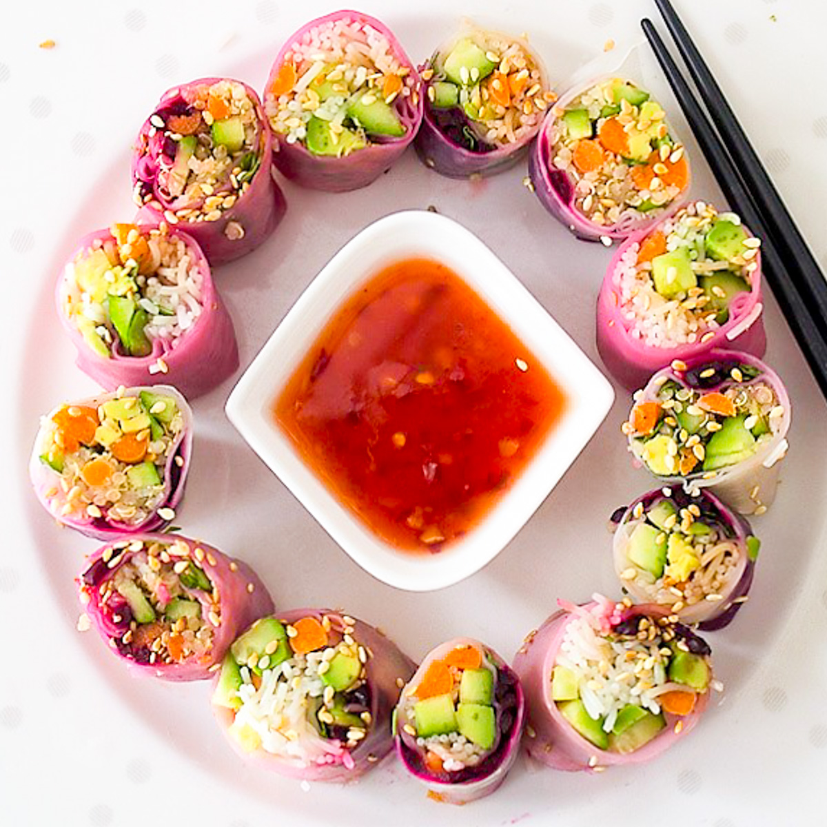 cut rice paper rolls forming a circle around dipping sauce bowl.