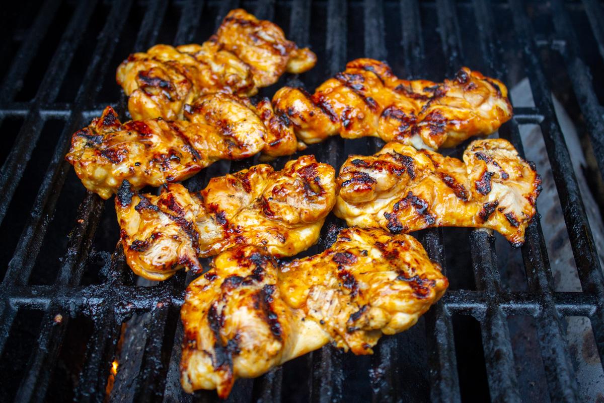 marinated thighs grilling on bbq