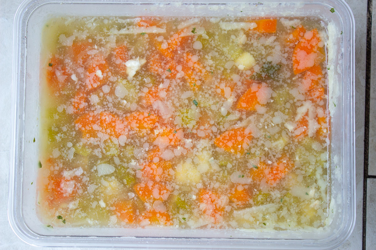 congealed turkey soup with fat on top in container