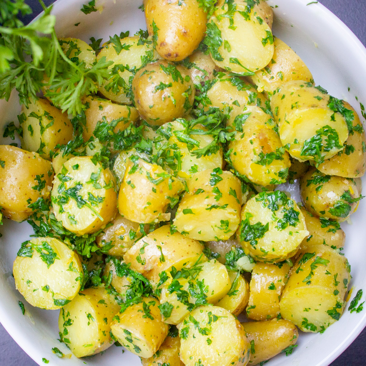 parsley potatoes with zest in white bowl