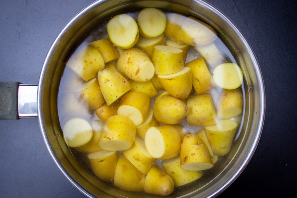 cut potatoes with water in pot