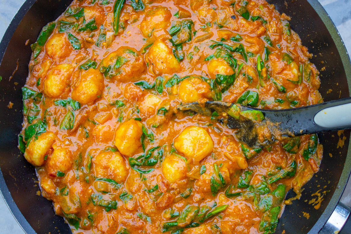 indian style gnocchi in sauce in skillet