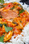 coconut curry salmon over white rice in a bowl