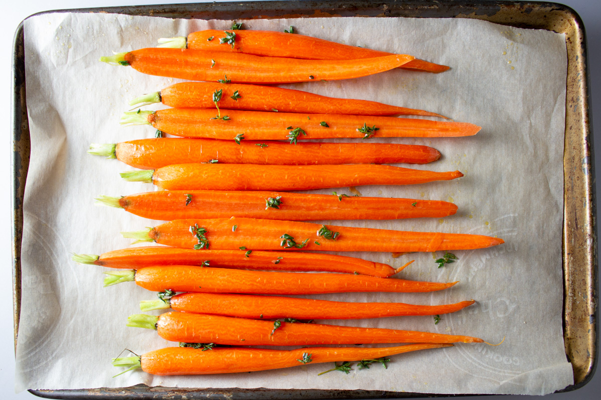 glazed carrots with thyme on roasting pan