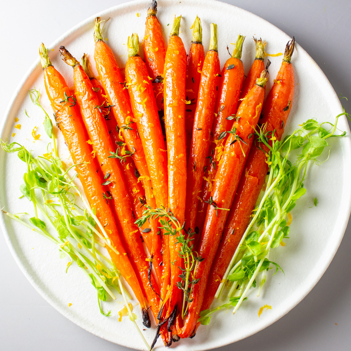 maple glazed carrots on round white plate.