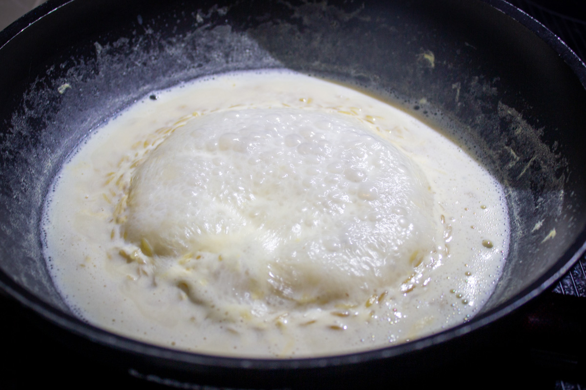 milk and broth boiling in skillet