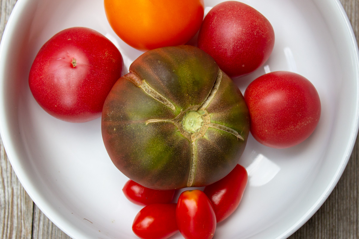 fresh heirloom tomatoes on plate.