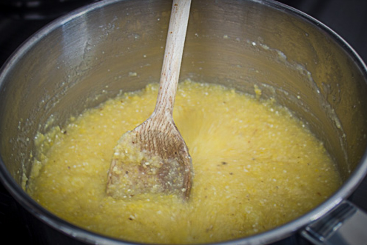 partially cooked polenta in pot.