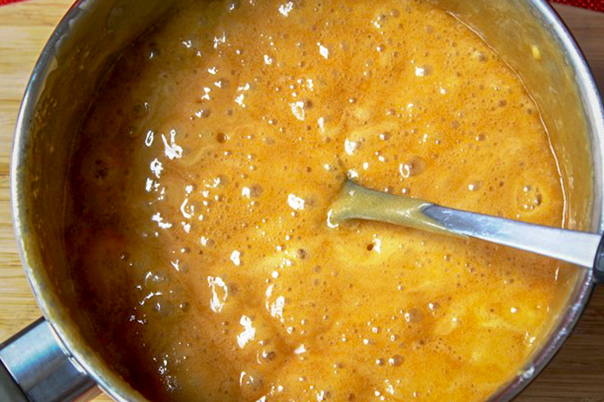 caramel sauce in pot bubbling.