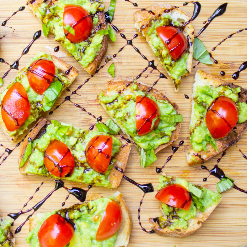 tomatoes on crostini with balsamic drizzle on cutting board