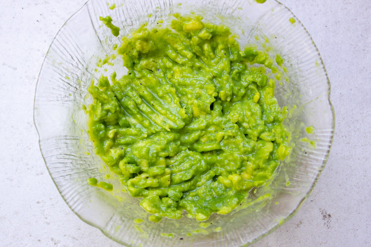 mashed avocado in small bowl. 