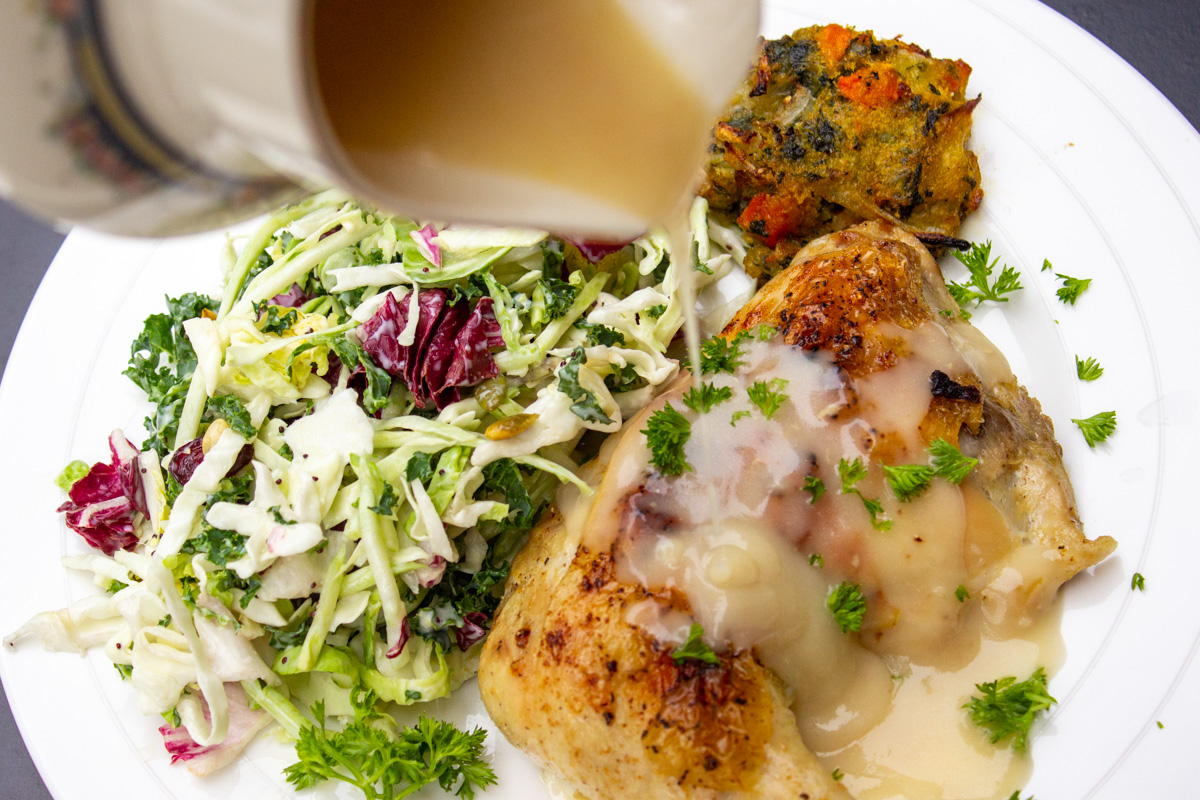 better than bouillon gravy pouring on roasted chicken on a plate.