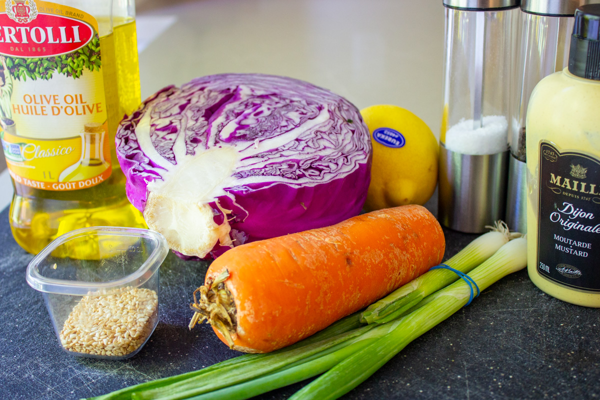 half purple cabbage, carrot, lemon, sesame seeds, green onion, Dijon, garlic, olive oil, salt, pepper