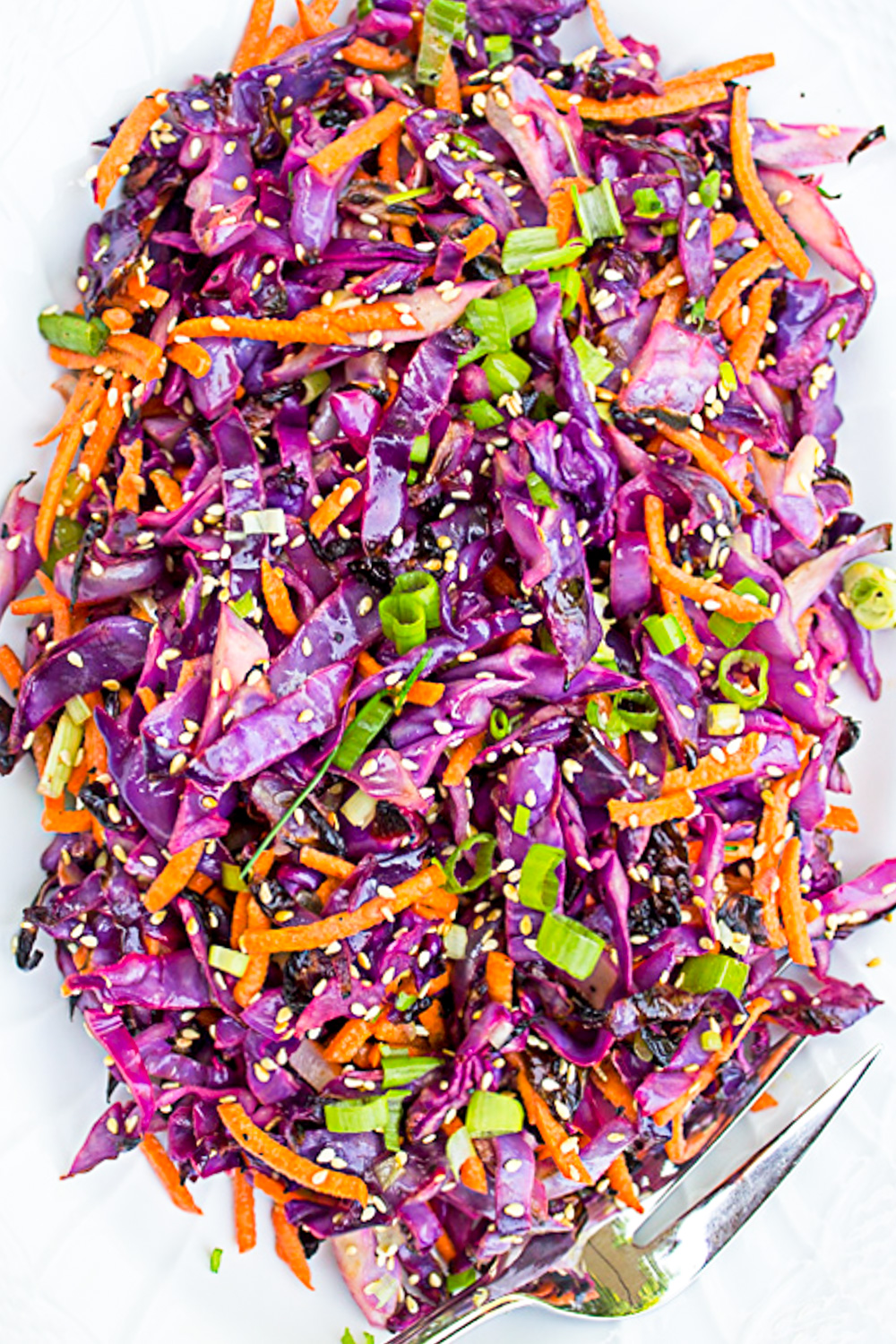 grilled purple cabbage slaw on white plate.