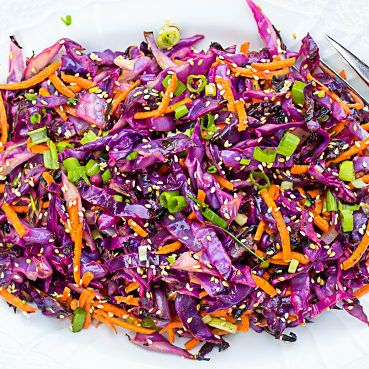grilled purple cabbage slaw on white plate.