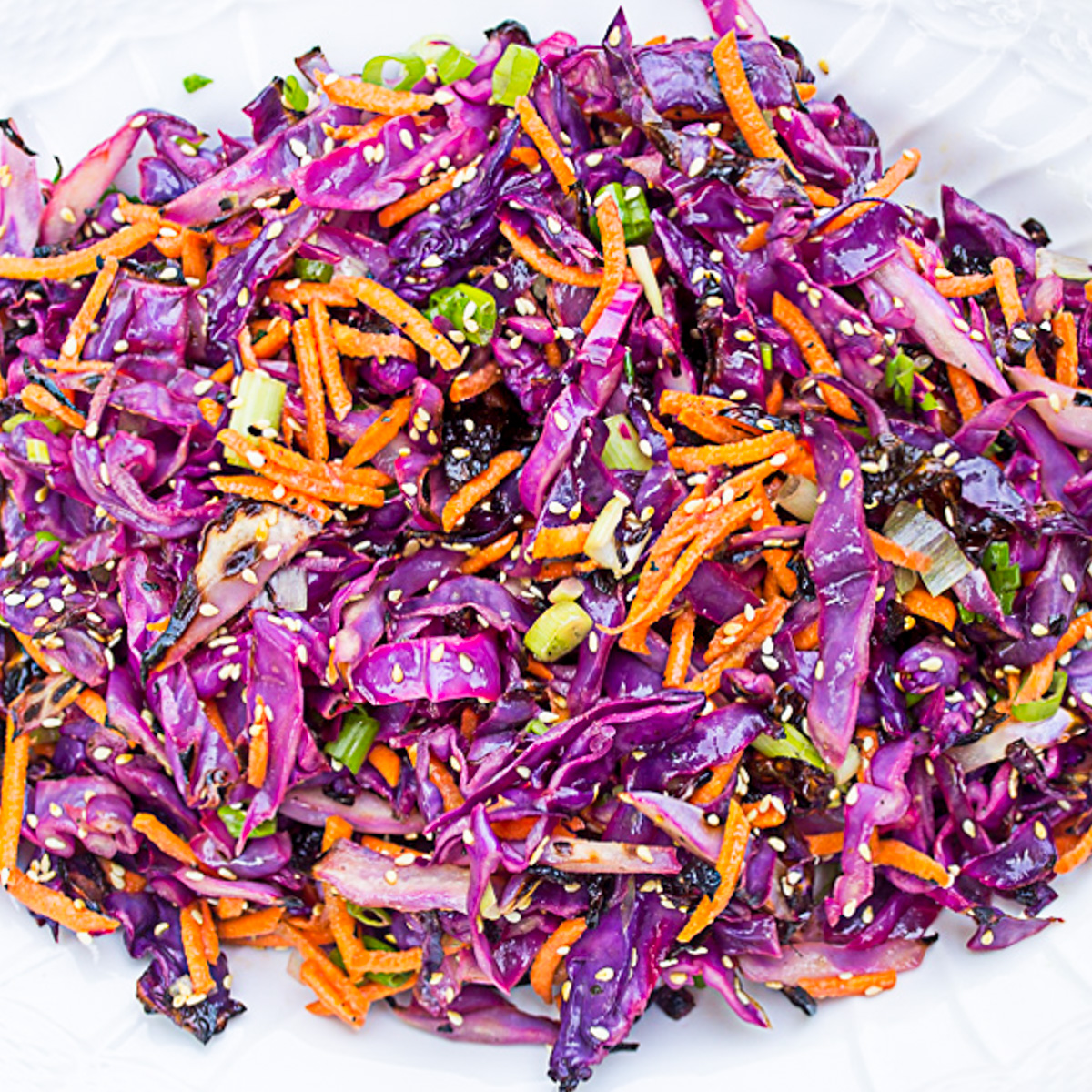 grilled purple cabbage slaw on white plate.