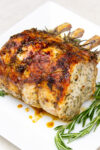 roasted rack of pork with rosemary on plate