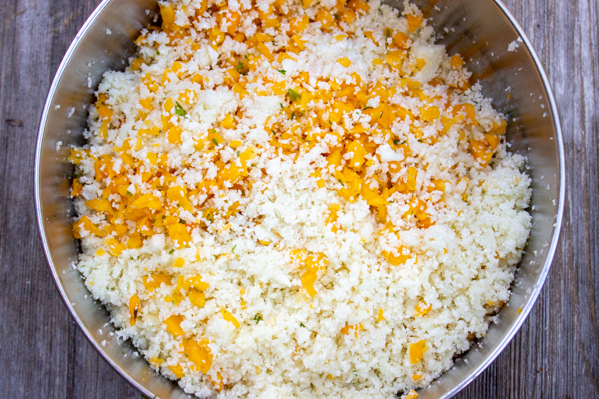 riced cauliflower and squash in food processor bowl.