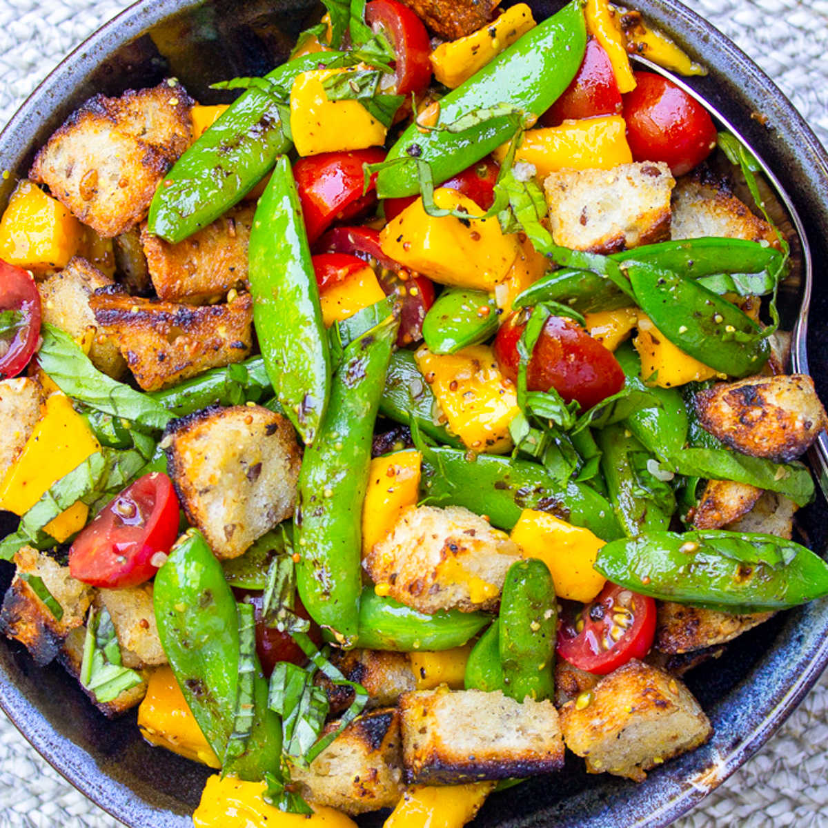 panzanella salad with charred snap peas in bowl.