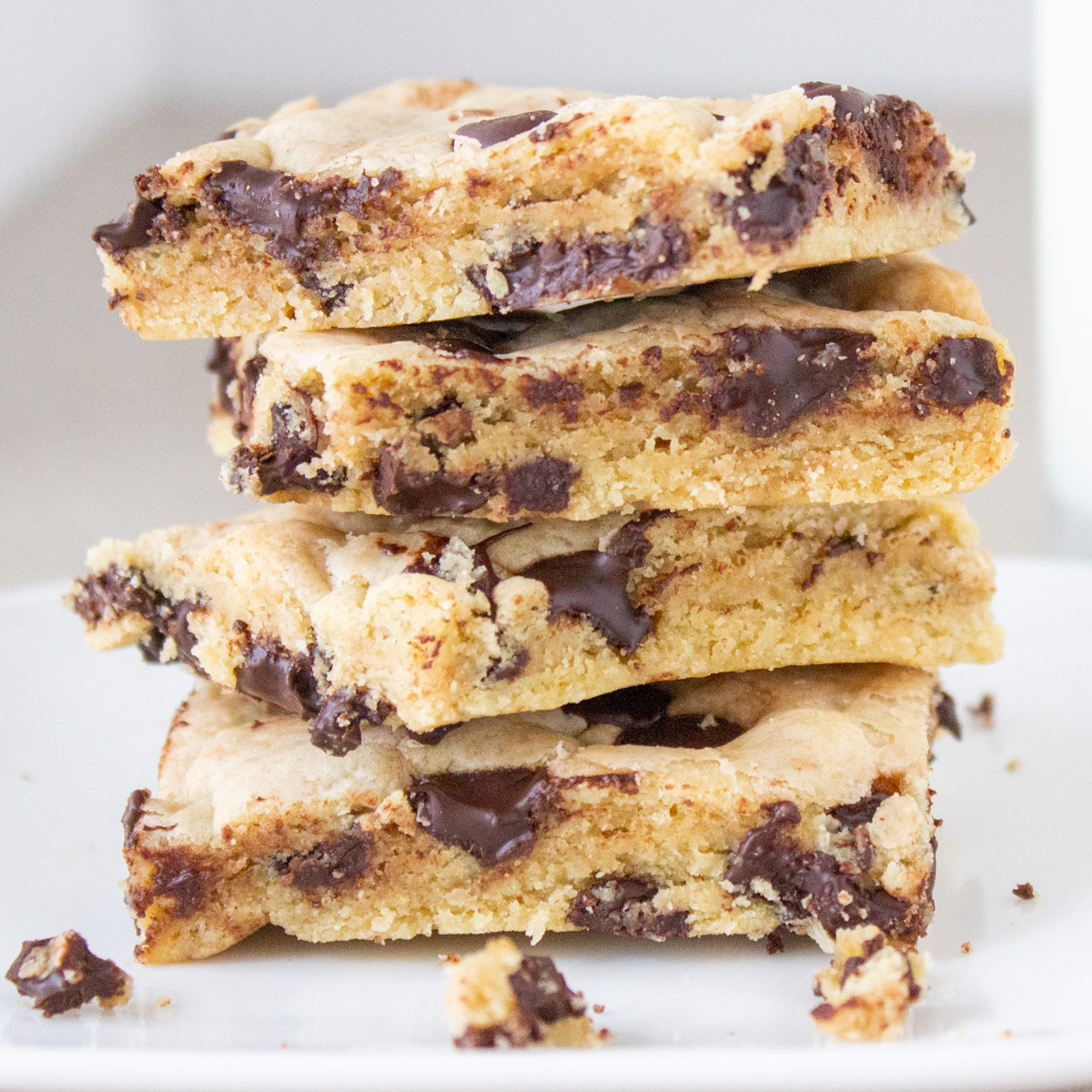 4 chocolate chip bars stacked on a plate.