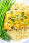 baked citrus salmon over quinoa with asparagus on plate.