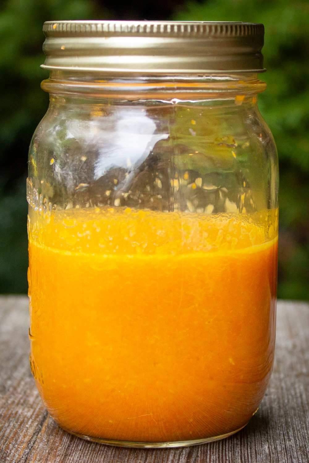 Japanese ginger salad dressing in jar on wood table.