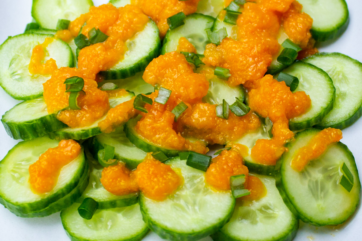 Japanese ginger salad dressing drizzled on sliced cucumbers.