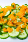 Japanese ginger salad dressing drizzled on sliced cucumbers.