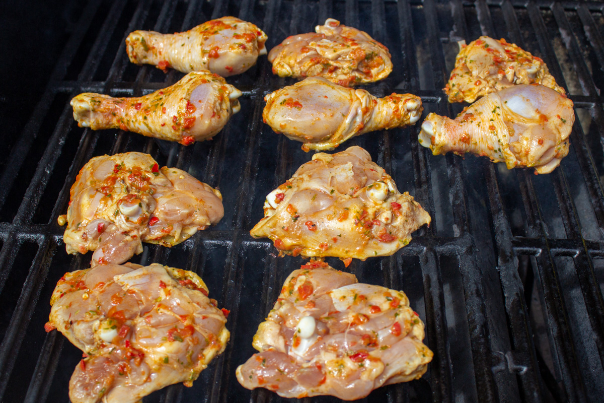 peri peri marinated chicken on grill cooking.