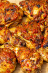 finished peri peri chicken pieces on cutting board