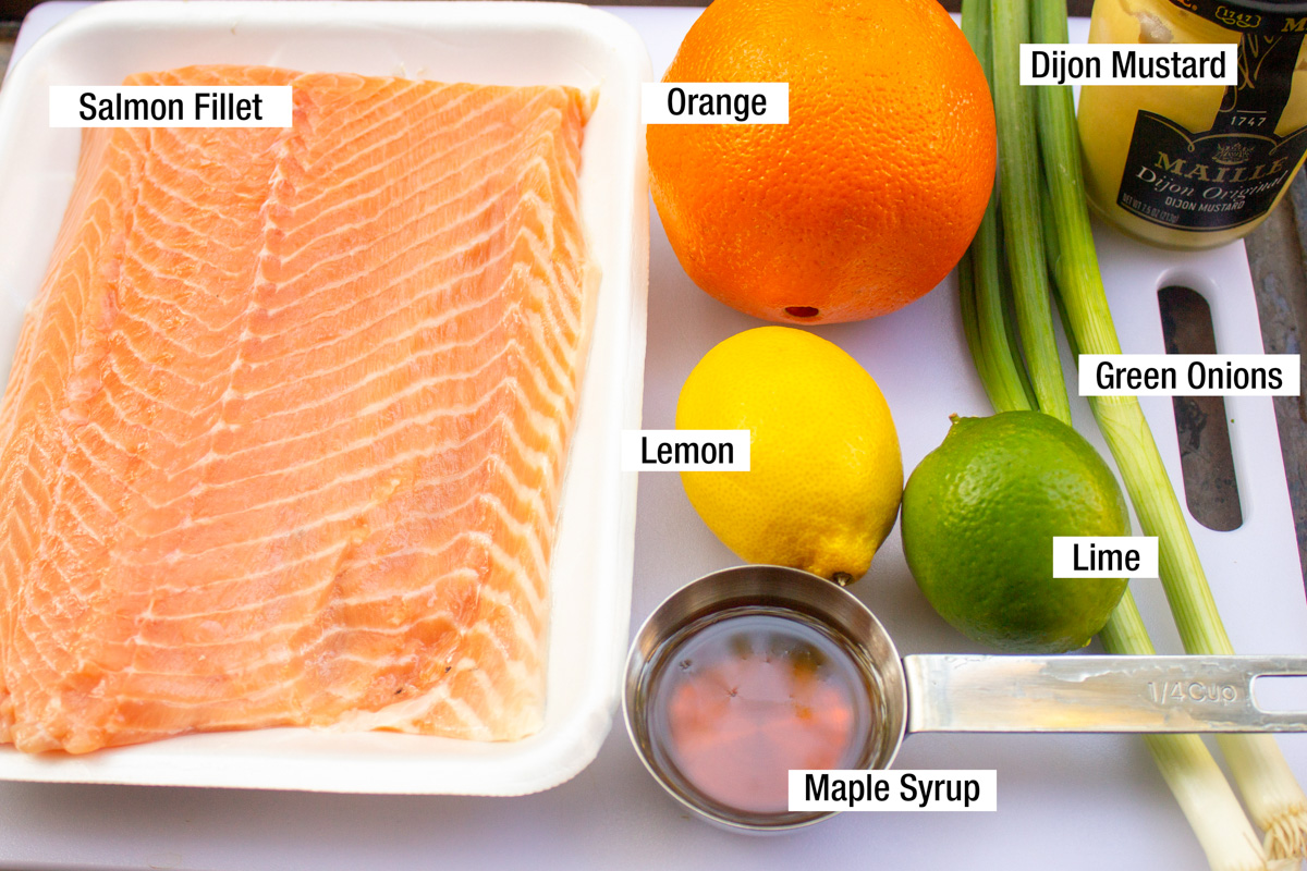 large salmon fillet, maple syrup, lemon, lime, orange, green onions