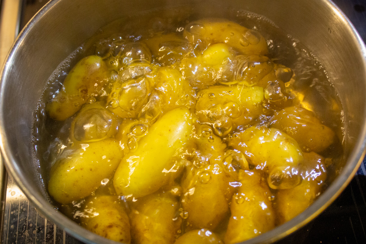 fingerling potatoes boiling in pot.