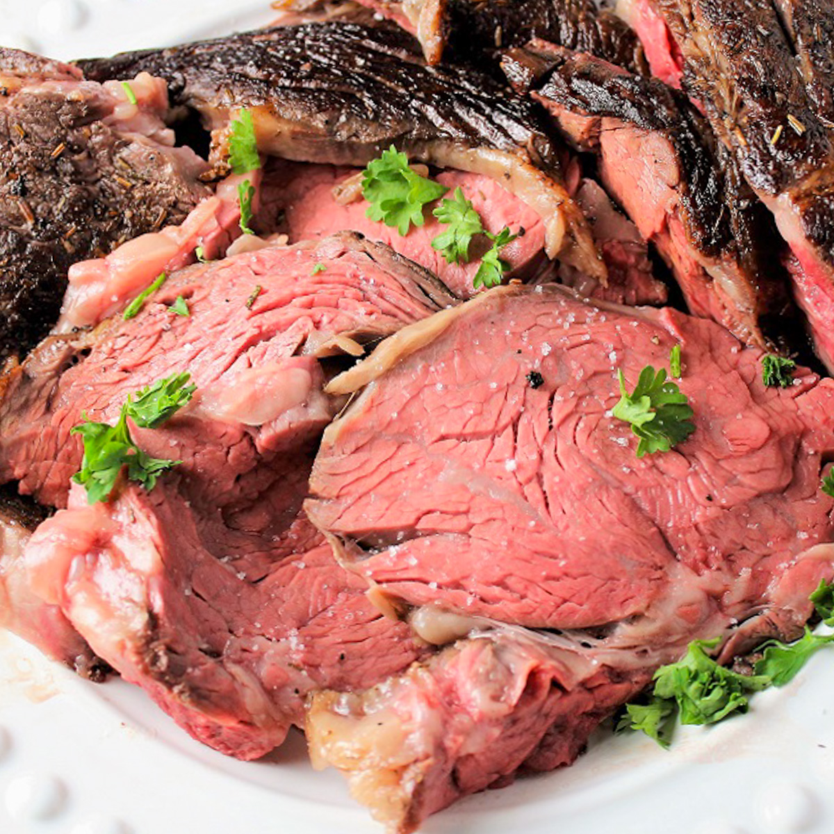sliced prime rib roast on plate.