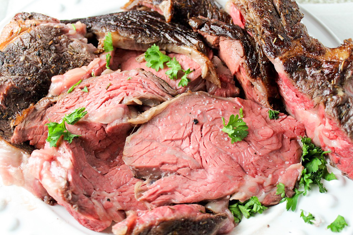 sliced prime rib roast on plate. 