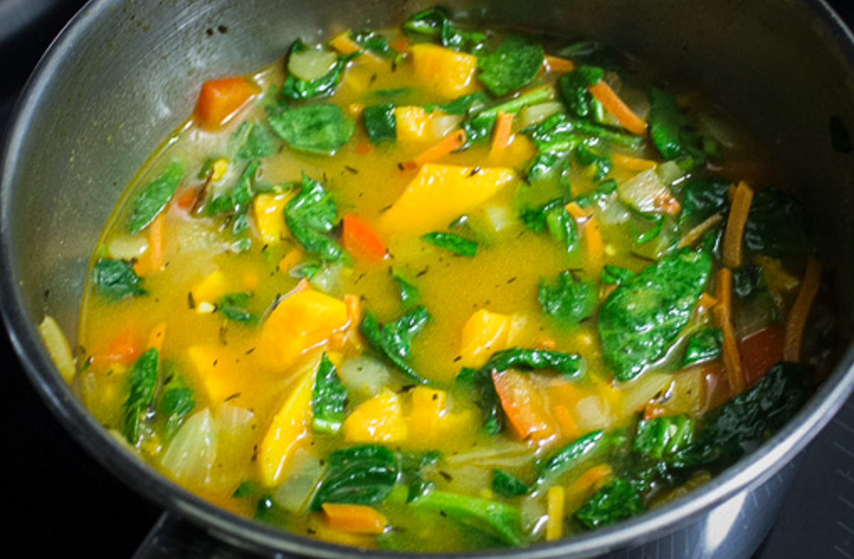 veggies, seasonings and broth in pot.