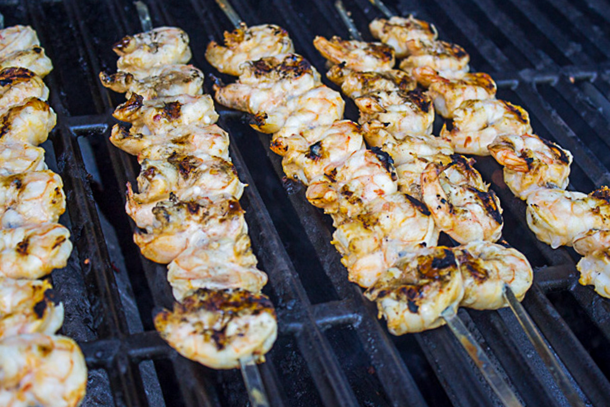 skewers of shrimp on grill.
