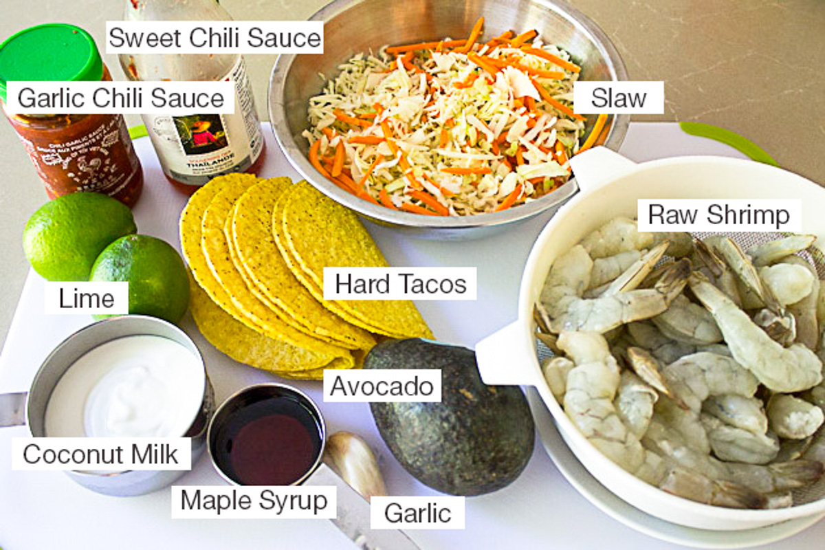 bowl of raw shrimp, hard tacos, avocado, coconut milk, sweet chili sauce, garlic chili sauce, lime, slaw, garlic.