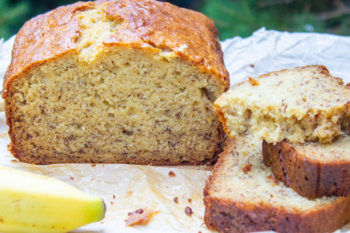 banana bread loaf with a few slices on the side.