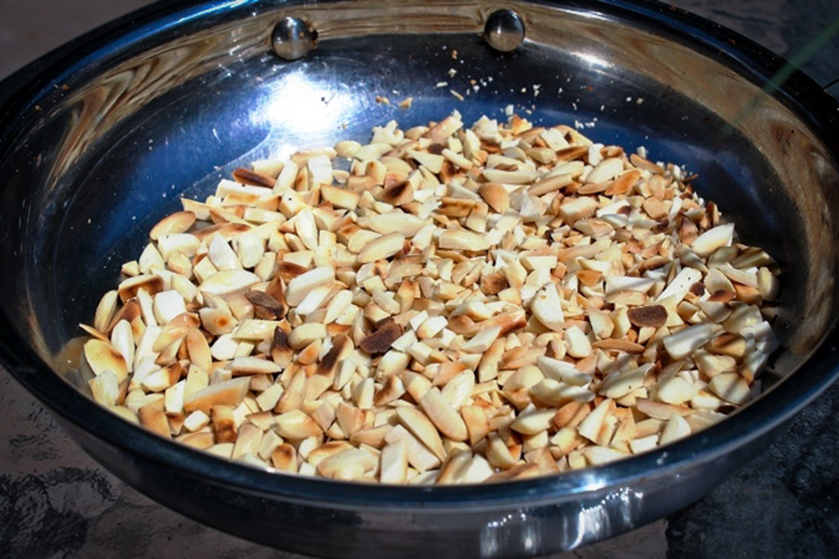slivered almonds toasting in pan.