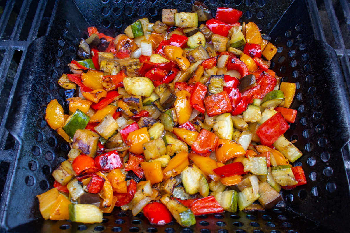 diced veggies in grill basket on grill.