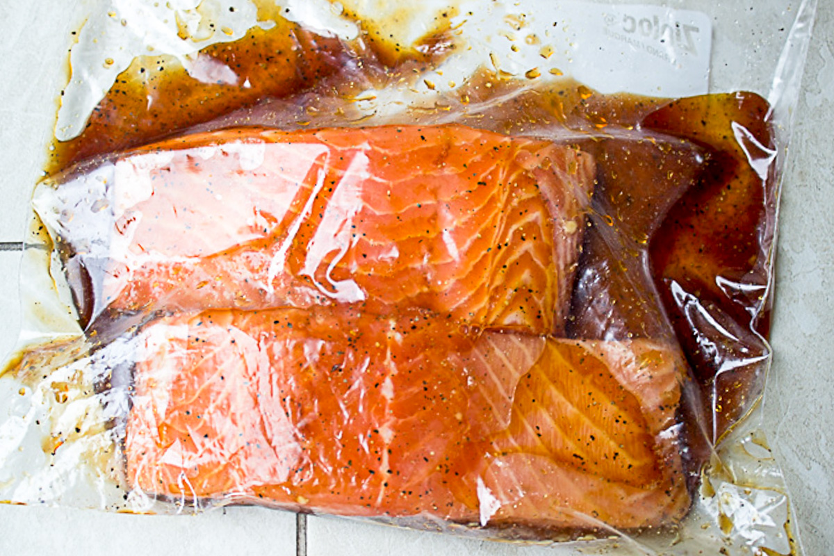 2 salmon fillets marinating in zipper lock bag.