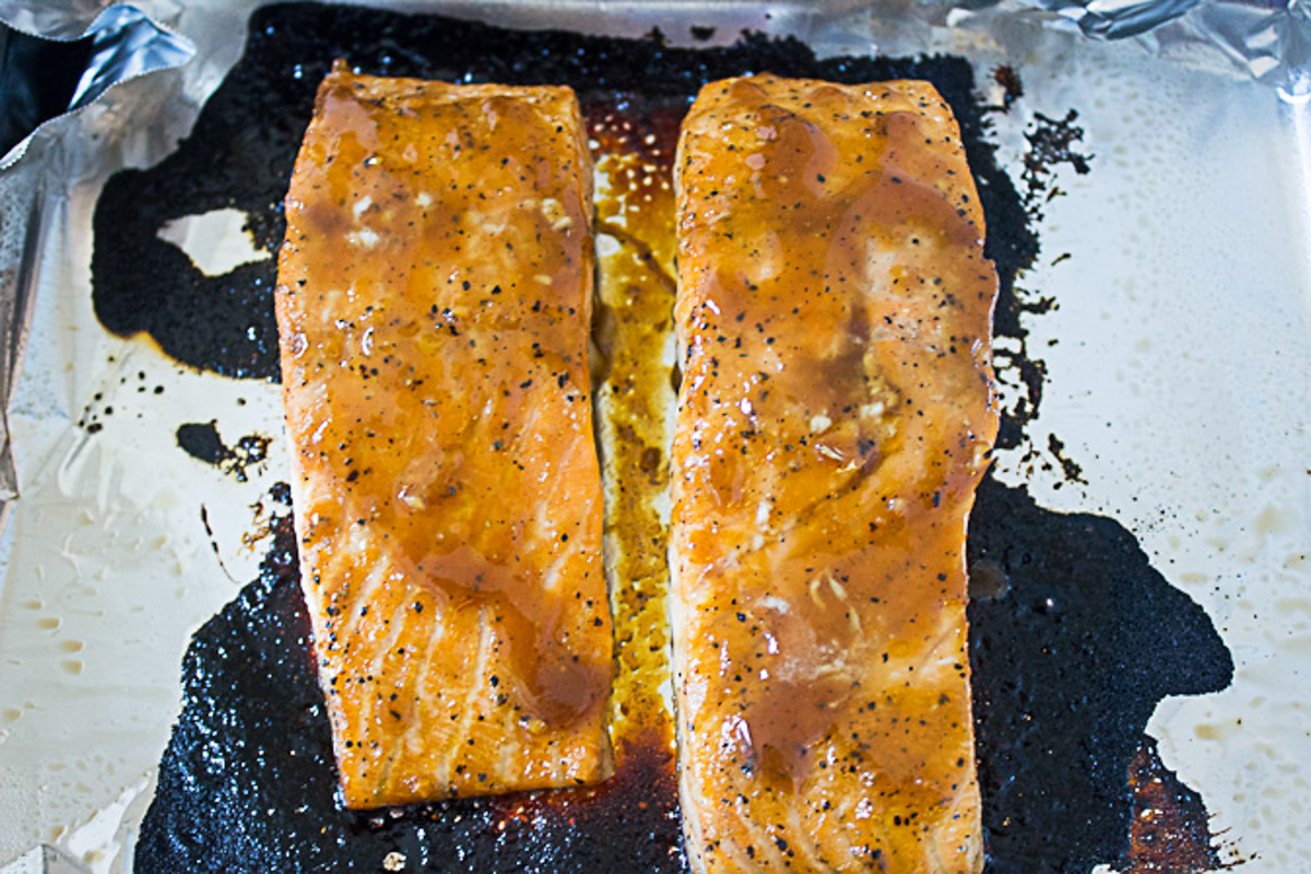 two salmon fillets baked on foil-lined pan.