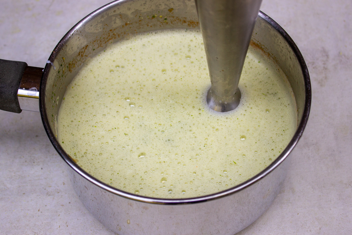 blended corn soup with immersion blender in pot.